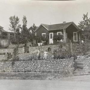 a black and white photo of a stone wall in front of a house at 7min Walk to Courthouse Plaza! Historic Cottage in Prescott