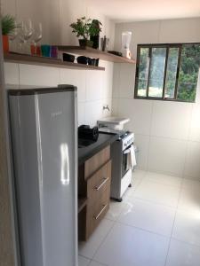 een keuken met een roestvrijstalen koelkast en een fornuis bij Dei Fiori Guaramiranga in Guaramiranga