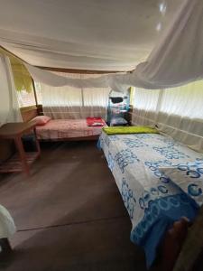 a bedroom with two beds in a tent at Katari Center in Tarapoto