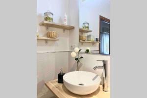 a bathroom with a white sink on a wooden counter at Céntrico apartamento con terraza y WIFI in Ronda