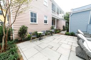 a patio with chairs and a table in front of a house at Guesthouse Charleston EAST 44 in Charleston