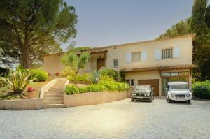 a house with a car parked in front of it at Villa Siena in Roquebrune-sur-Argens