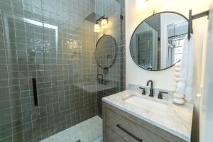 a bathroom with a sink and a mirror at Guesthouse Charleston EAST 46 E in Charleston +19 photos
