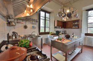 a kitchen with a counter with vegetables on it at Villa Teresa in Cavriglia