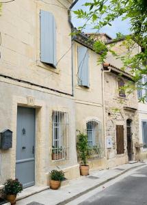 a building with blue doors and windows on a street at L'oustaou d'Arles in Arles +27 photos