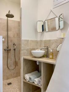 a bathroom with a sink and a shower at L'oustaou d'Arles in Arles