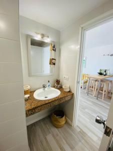 a bathroom with a sink and a mirror at Lagos del cotillo in Cotillo