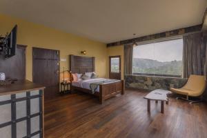 a bedroom with a bed and a large window at Fort WindShire in Nuwara Eliya +89 photos