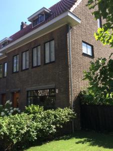 a large brick house with a window at Eikenburg B&B in Eindhoven