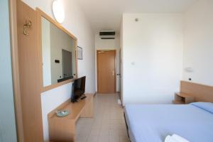 Postel nebo postele na pokoji v ubytování Piccolo Hotel