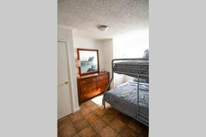 a bedroom with a bunk bed and a mirror at Central Automobile Alley Modern 1BDR - WIFI in Oklahoma City