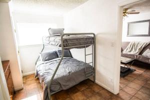 a bedroom with two bunk beds in a room at Central Automobile Alley Modern 1BDR - WIFI in Oklahoma City