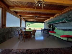 a living room with a table and chairs and a couch at Ranč Stojnšek in Rogaška Slatina