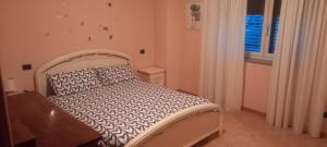 a bedroom with a white bed in a room at Casa "La Forcella" in Brembilla
