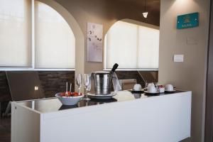 a kitchen with a island with a counter top at Principe Alogna Hotel & SPA in Altavilla Milicia