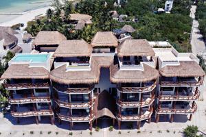 an aerial view of a resort with thatched roofs at Casa Astral Luxury Hotel in Holbox Island