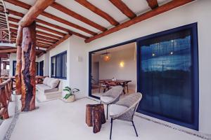 a living room with chairs and a large window at Casa Astral Luxury Hotel in Holbox Island
