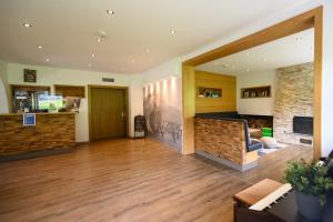 a living room with a fireplace and wooden floors at Sonnenburg Hotel in Ehrwald