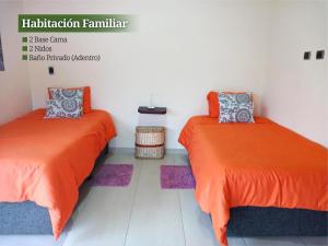 two beds sitting next to each other in a room at VILLA CUCHA in Monguí