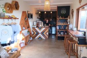 a woman standing at a counter in a store at Amber Light Wilderness Beach Cottage in Wilderness