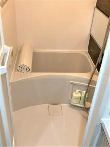 a bathtub in a small bathroom with a towel on it at Marvelous Ryogoku - Vacation STAY 74210v in Tokyo