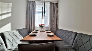 a dining room with a wooden table and two chairs at Vienna CityApartments - Luxury 2 in Vienna