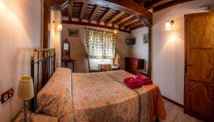 a bedroom with a bed with red pillows on it at La Casa del Burro in La Alberca