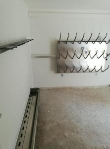 a room with a white wall with metal pipes at Apartments Zwigl in Flattach
