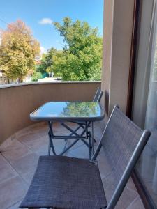 a blue table and a chair on a balcony at Stella Guesthouse in Sapareva Banya