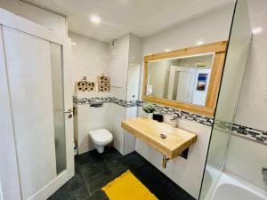 a bathroom with a sink and a toilet and a mirror at Apartmán Kežmarok in Kežmarok +65 photos