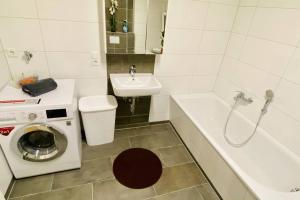 a bathroom with a washing machine and a sink at FeWo Seenest #Netflix #Seenähe #Einkaufen von Harztraveler in Goslar +19 photos