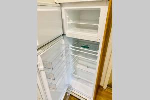 an empty refrigerator with its door open with its door openktop at FeWo Seenest #Netflix #Seenähe #Einkaufen von Harztraveler in Goslar