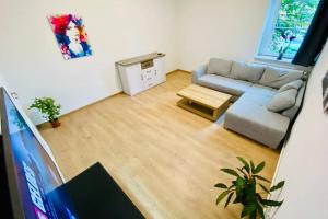 a living room with a couch and a flat screen tv at FeWo Seenest #Netflix #Seenähe #Einkaufen von Harztraveler in Goslar