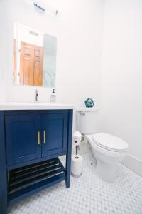 a bathroom with a blue cabinet and a toilet at Guesthouse Charleston SOUTH 82 B in Charleston