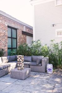 a couch sitting on a patio in front of a house at Guesthouse Charleston SOUTH 82 B in Charleston
