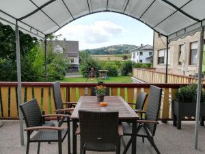 a wooden table and chairs on a patio with an archway at Attractive Holiday Home in Rotenburg with Garden in Dankerode