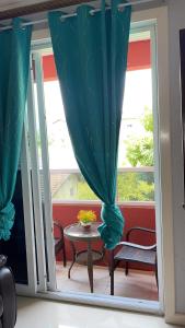 a patio with a table and a window at Jamrock Suites in Kingston