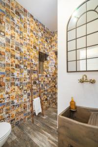 baño con mosaico en la pared y bañera en Casa Celeiro, en Estômbar