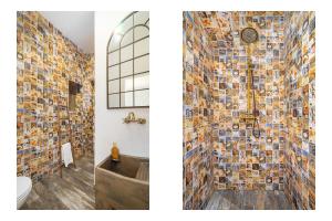 Un baño con una pared de mosaico y un inodoro. en Casa Celeiro, en Estômbar 13 fotos más