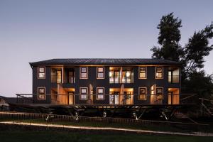 a large black house with a balcony on a track at Anoka Apart Hotel Boutique in Frutillar