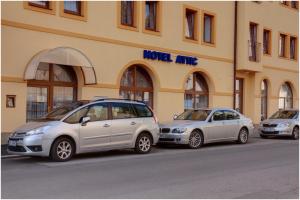 three cars parked in front of a building at Attic Hotel in Prague