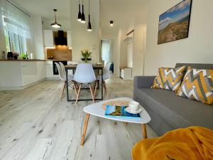 salon z kanapą i stołem w obiekcie Apartament Jak Marzenie w mieście Ustrzyki Dolne