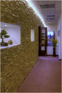 a stone wall in an office with a bonsai tree on it at Attic Hotel in Prague