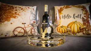 a bottle of wine and two wine glasses on a table at Forester's Retreat Glamping - Cambrian View- Vaccinated dogs over the age of 2 are accepted in Aberystwyth +34 photos