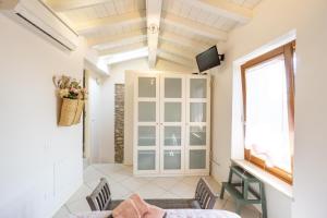 a living room with a window and a tv at La Casetta in Cittadella in Lonato