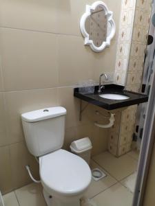 a bathroom with a toilet and a sink at Ap Acolhedor in Fortaleza