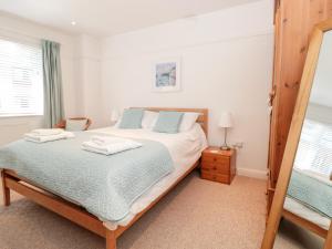 a bedroom with a bed with two towels on it at Sail View in Dartmouth