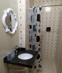 a bathroom with a sink and a shower at Ap Acolhedor in Fortaleza