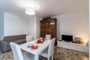 a living room with a white table and a couch at The house with red sunsets in Varenna