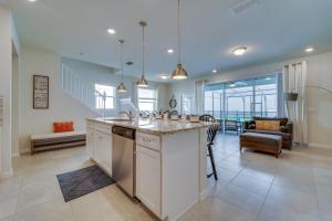 a kitchen with an island in the middle of a room at Windsor Island Resort 5 Bedroom Townhome Private Pool Disney in Davenport